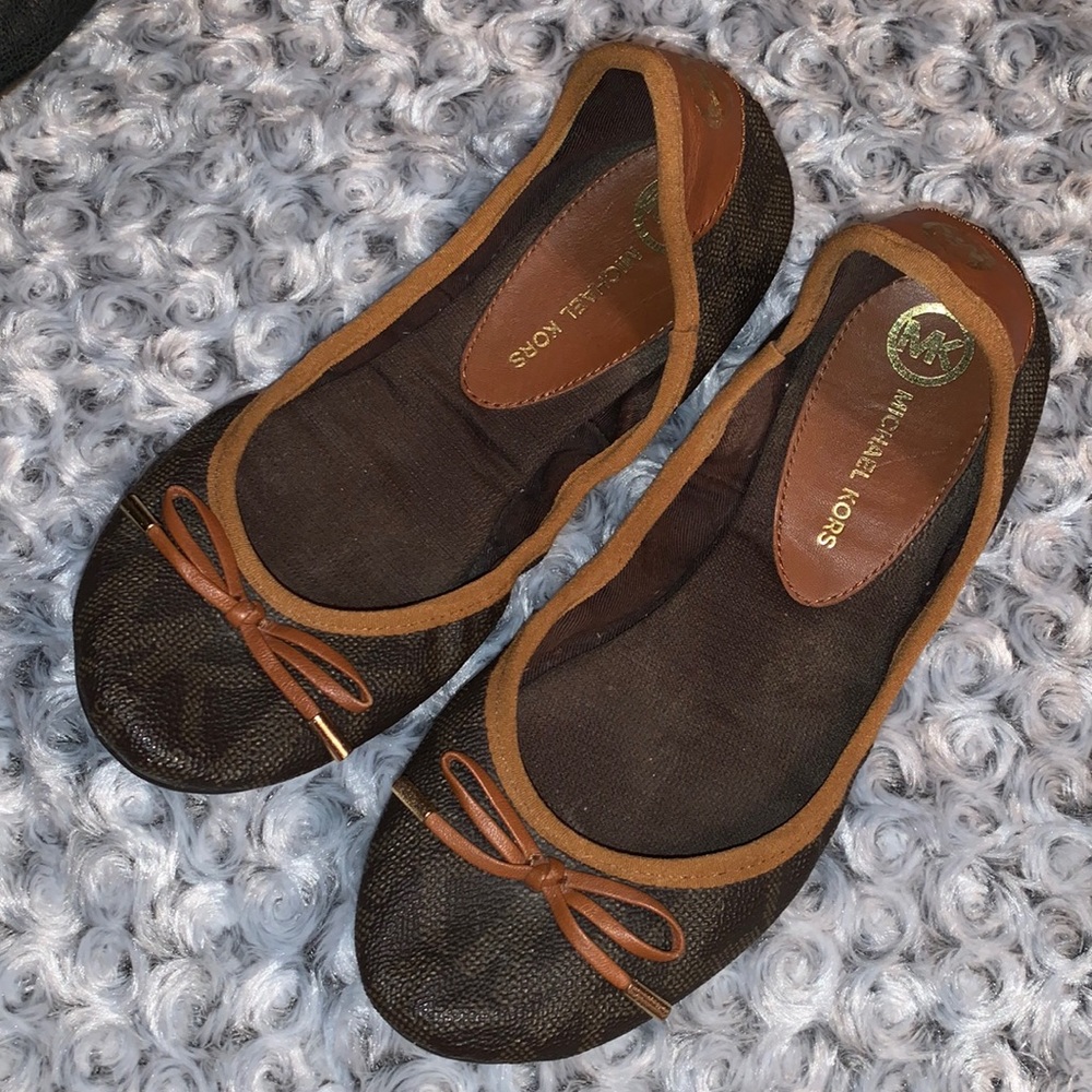 Used MK brown flats; Size 7.